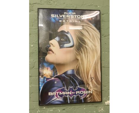 A framed signed print of Alicia Silverstone as Bat Girl from the movie Batman and Robin.