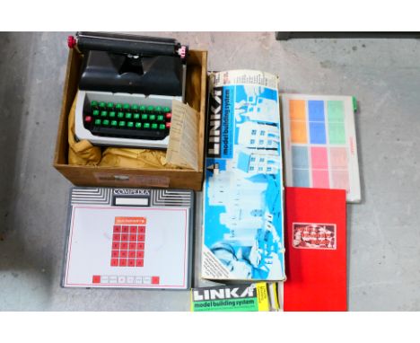 A Lilliput Mark IV typewriter contained in shipping crate, a folding chess board and an unboxed Compedia 1980s Electronic Enc