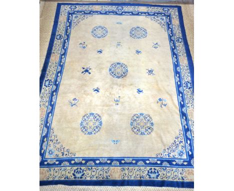 An antique Chinese Peking carpet, blue symbols on natural ground, circa 1910, 3.35 x 2.60 m