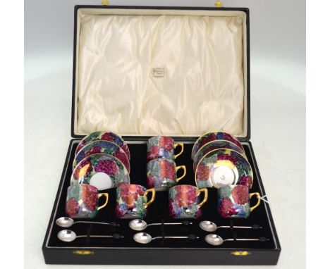 A set of six porcelain lustre coffee cans and saucers to/w six silver bean end coffee spoons, Birmingham 1931, all in present