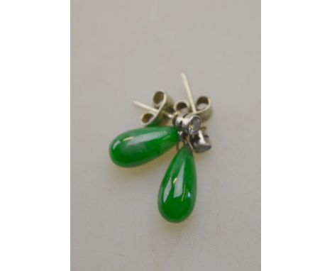 A pair of diamond and jade drop earrings for pierced ears, the circular diamond above a pendalique shaped jade drop Condition