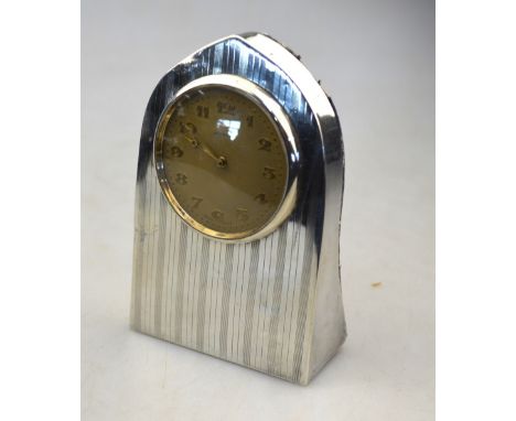 A silver lancet-cased desk clock with engine-turned decoration, Cornelius Desormeaux Saunders & James Francis (Frank) Holling