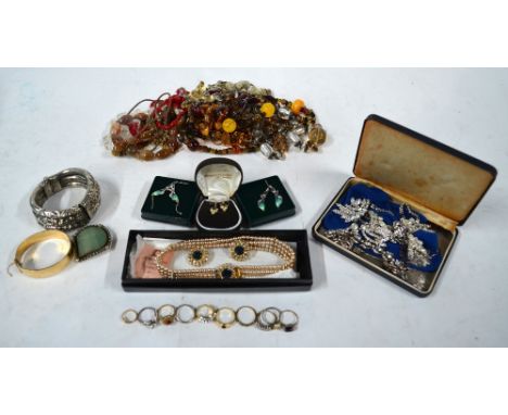 A large collection of vintage jewellery including paste set brooches, earrings, bracelets etc, stone and other bead necklaces