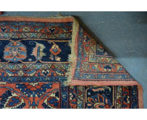 An old Persian Sarouk carpet, the floral vine design on dark coral ground, 4.10 x 2.56 m Condition Report even overall wear, 