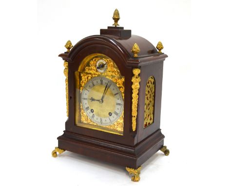 A late 19th Century German mahogany mantle clock, the eight-day movement quarter-striking on two coiled gongs, the arched dia
