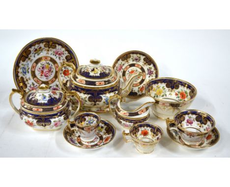 An early 19th century Ridgway tea service decorated with finely painted polychrome flowers within a mazarine blue and gilded 