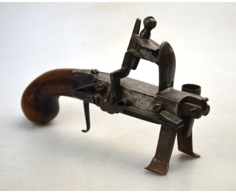 An early 19th century flintlock tinder lighter with walnut pistol-grip, 18 cm long