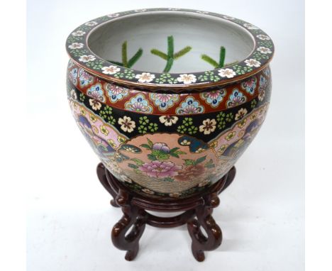A polychrome enamel fish bowl or jardiniere, 37cm diameter, post Qing Dynasty; with wood stand (2)