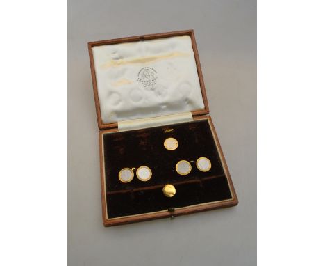 A part set of gentleman's accoutrements, white and yellow metal circular engine turned, including a pair of cufflinks, one bu