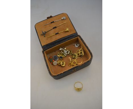 A small leather box containing a pearl and diamond stick pin, diamond and enamel duck in flight stick pin, and yellow gold bu