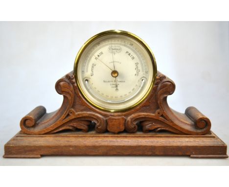 A Victorian aneroid barometer in brass drum case, the silvered dial with curved mercury thermometer, by Negretti & Zambra, Lo