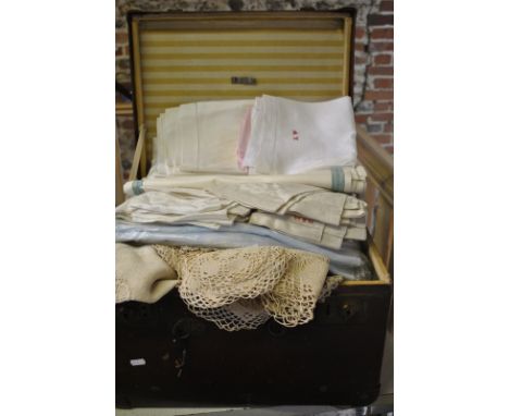A small deep vintage trunk containing a quantity of damask and other sets of table napkins, crocheted doilies etc. etc.