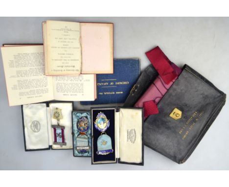 Masonic: two silver and enamel jewels and another silver example, to/w an apron in leather pouch and three small Books of Cer