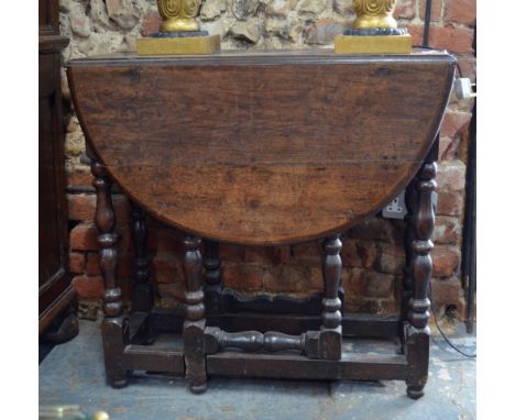 A 17th century oak small oval gateleg table with end drawer, on baluster turned supports (f/r), 110 x 78 cm