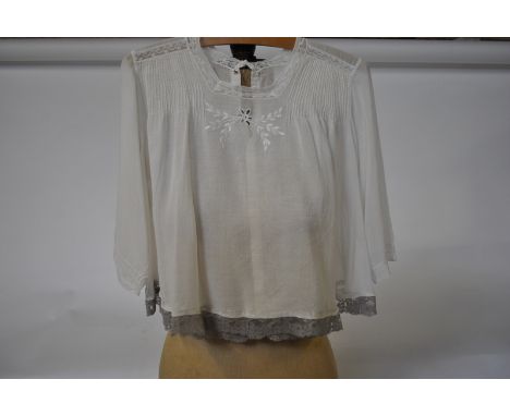 An Edwardian cotton lawn blouse edged with grey lace, a similar blouse with inset lace to sleeves, a cotton lawn blouse with 