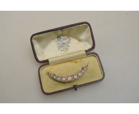 An opal and diamond open crescent style brooch yellow metal set on pierced gallery in fitted box supplied by H R Marsh, Bath 