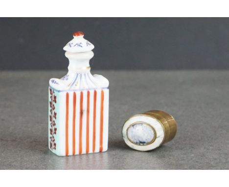 A brass pill box with decorative polished stone lid, together with a ceramic snuff / perfume bottle with floral decoration 