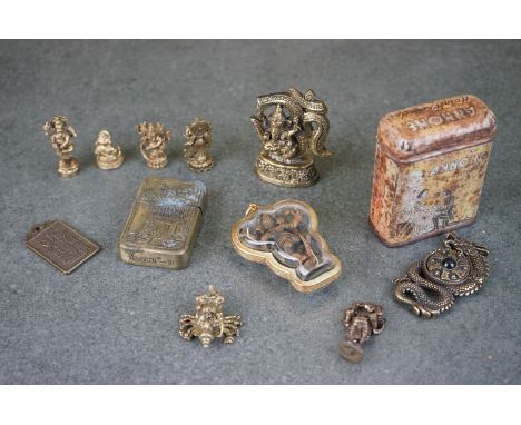 A small group of collectables to include oriental amulets, lighter and an advertising tin. 