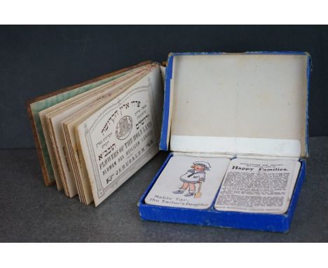 An olive wood souvenir book of pressed plant from Jerusalem together with an early 20th century Happy Families game by Chad V