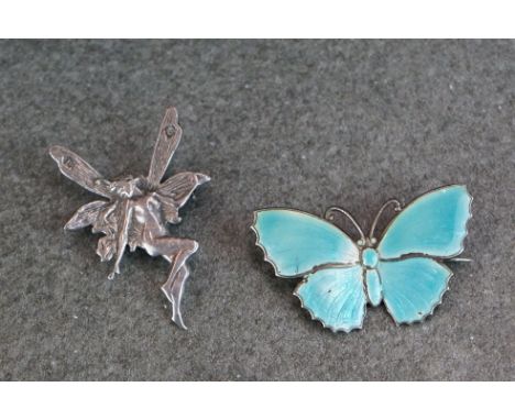 A silver and blue enamel butterfly brooch together with a silver fairy brooch. 