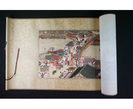 A Chinese embroidered scroll picture depicting a street market scene. 
