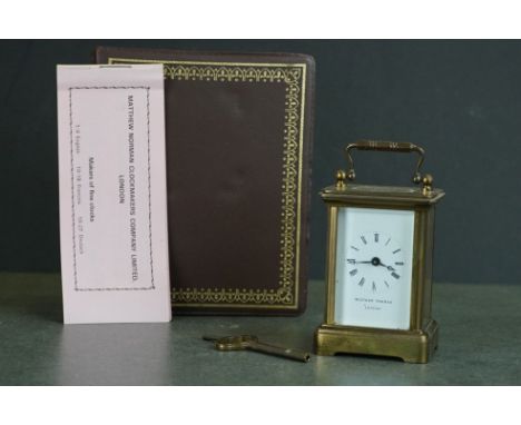 A small brass cased carriage clock by Matthew Norman of London complete with box and key. 