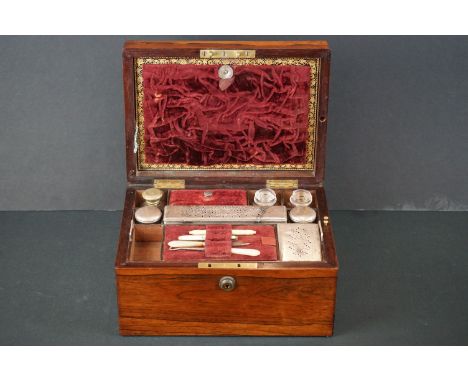 19th century Rosewood Dressing Box, the hinged lid opening to an interior mostly fitted including lidded jars, bottles and ma