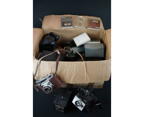 A collection of vintage photographic equipment to include polaroid and box cameras.