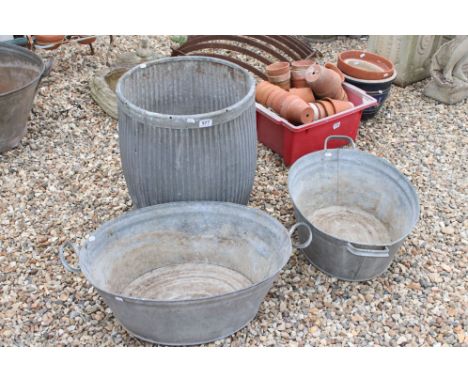 A large galvanised steel planter, height approx 52cm together with two small galvanised steel baths. 