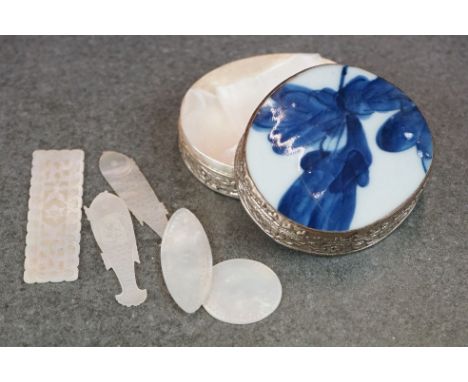 A collection of 19th century mother of pearl gaming counters contained within a white metal box with blue and white ceramic l