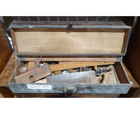 Wooden tool box containing various vintage hand tools