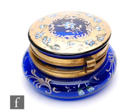 A 19th Century continental trinket jar of compressed circular form with cover, all decorated with gilt and enamelled flowers 