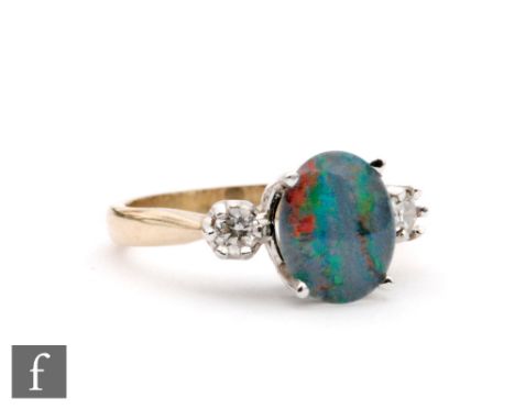 A 9ct hallmarked opal triplet and diamond three stone ring, central opal flanked by diamonds, ring size O. 