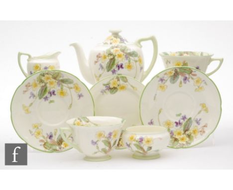 A late 1930s Royal Doulton tea for two decorated in the April V 2000 pattern comprising teapot, two cups and saucers, milk ju