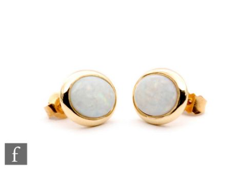 A pair of 14ct opal stud earrings, oval cabochon cut stones to as wide collar setting, total weight 2g. 