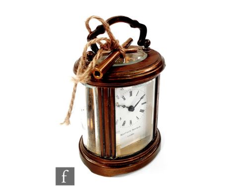A 20th Century carriage clock with oval bevelled glass panels, the white enamelled dial signed 'Matthew Norman, London' and w