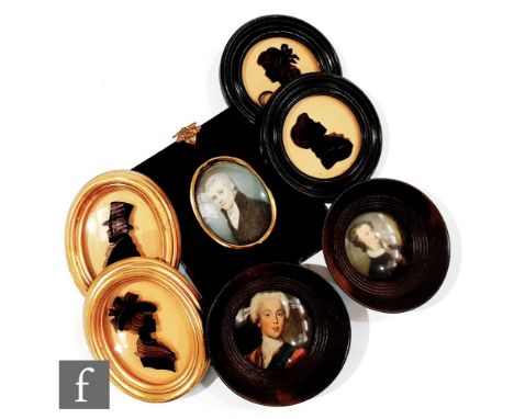 A 19th Century painted miniature of a Georgian gentleman wearing a black cloak, a pair of silhouettes in oval gilt frames, a 