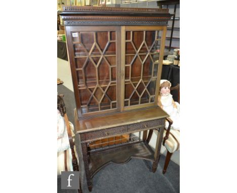 An early 20th Century mahogany collectors cabinet in the Chippendale revival taste, the galleried top above twin astragal gla