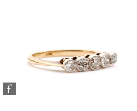An early 20th Century 18ct diamond five stone ring, millgrain set stone to knife edged shoulders, ring size K 1/2. 