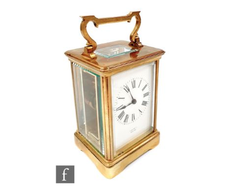 A 19th century French brass carriage clock, white enameled dial named Tyers Ltd Ealing in beveled glass case, height 13cm. 
