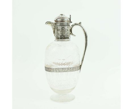 A VICTORIAN CUT GLASS AND SILVER MOUNTED CLARET JUG. London 1894, made by Charles Edward Nixon, the scrolling chased mount wi