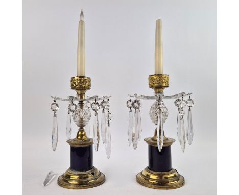 A PAIR OF LUSTRE CANDLESTICKS. late 19th / early 20th century, converted into table lamps, cut glass drops and brass casing, 