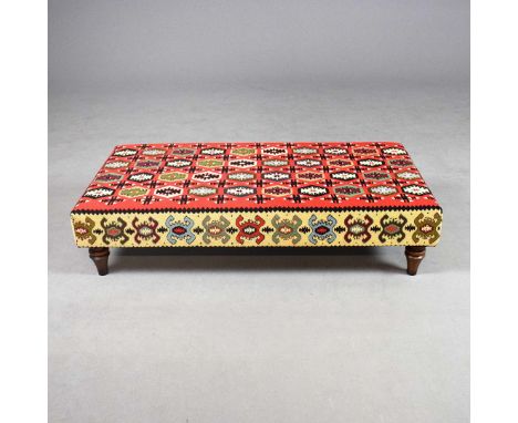 A KILIM UPHOLSTERED HEARTH STOOL. 30cm H x 125cm W x 64cm D.