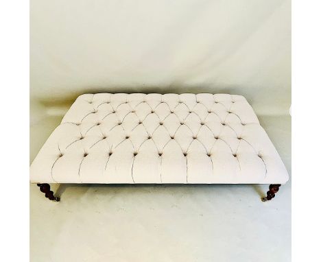 A LARGE HEARTH STOOL. in deep buttoned neutral linen upholstery, 33cm H x 154cm W x 92cm D.