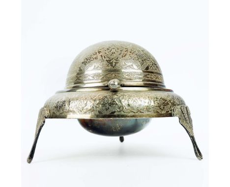 A PERSIAN WHITE METAL MUFFIN DISH. probably early 20th century, rotating cover, elaborately engraved throughout, raised on th