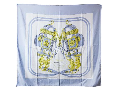 HERMÈS SHAWL "BRIDES DE GALA". by Hugo Grygkar, features a display of equestrian bridals on a pale blue background, silk, mad