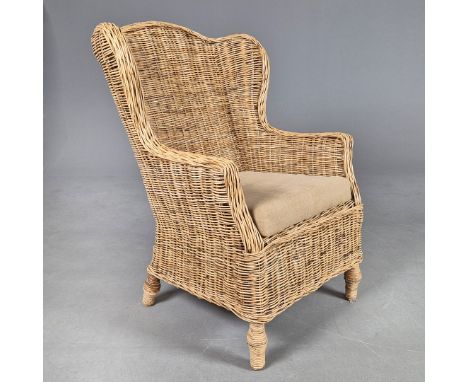 WICKER WINGBACK CHAIR. with a seat cushion.