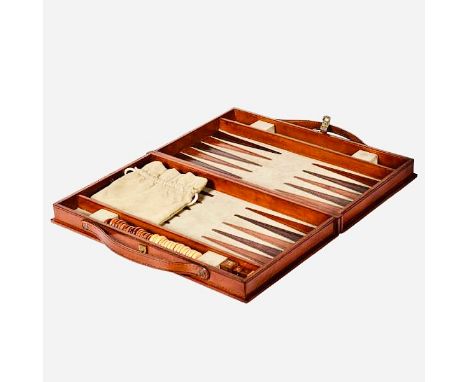 A TRAVELLING BACKGAMMON SET. tan leathered case, 23cm W x 40cm D x 7cm H.