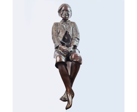 BRONZE, OF A SEATED BOY. with a hat at a jaunty angle. 54 cm t.