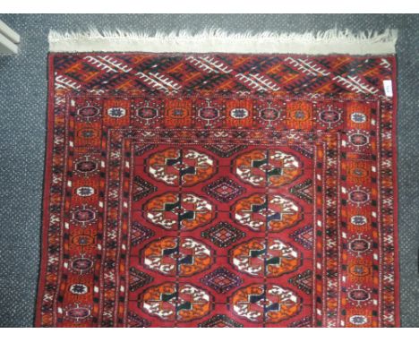 A 20th century carpet runner in the Tukemen style having burgundy ground